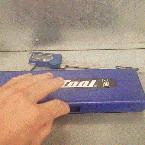 Animated Gif of a hand lifting up a blue Park Tool caliper case to reveal a smartphone, with its colourful case facing up.