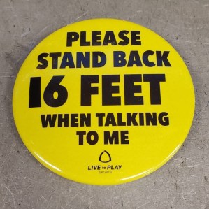 A yellow button reads PLEASE STAND BACK 16 FEET WHEN TALKING TO ME. The 1 has been made out of black electrical tape.